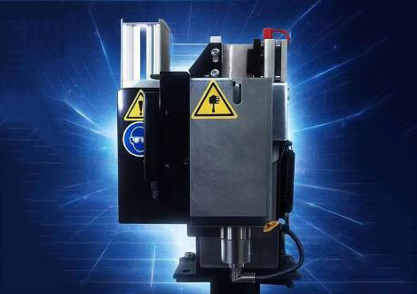 Automated welding gun cleaning station with robotic arm, industrial equipment, blue sparks, modern manufacturing setup, clean and organized workspace